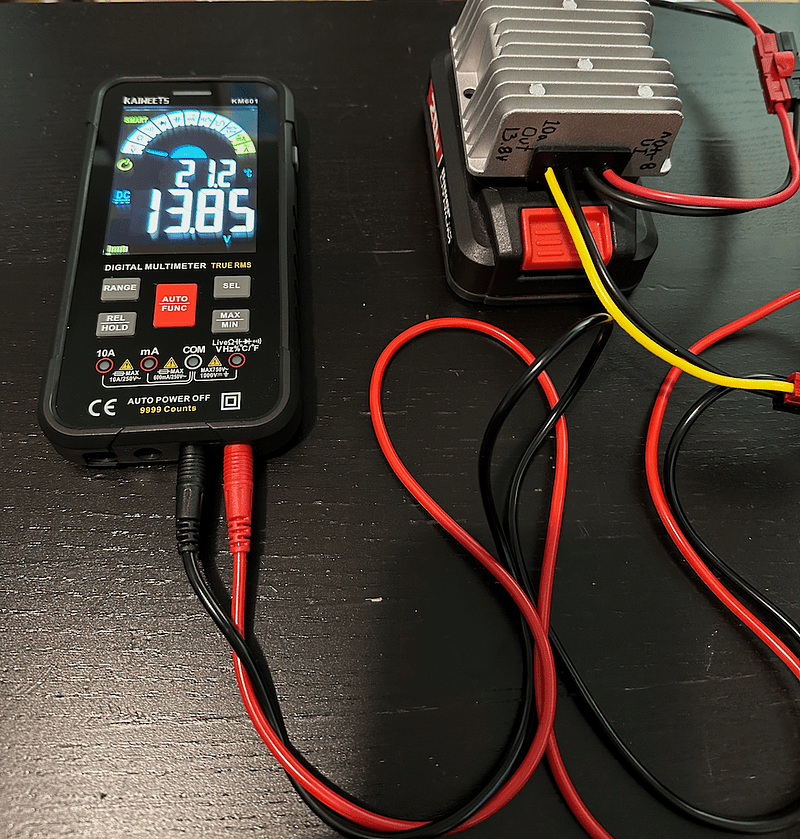 Multimeter showing output voltage of The Bauer-Pack with the 13.8v buck converter