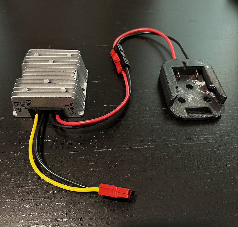 Battery output adapter and buck converter, connected